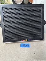 Front view of Lite-Brite Classic peg board showing perforated screen and logo