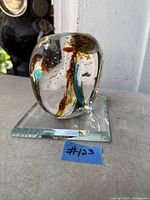 Full view of signed art glass sculpture on square glass base