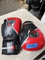 Front and side view of both Kimurawear boxing gloves showing logos, color, and size marking