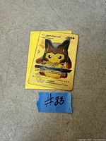 Front of gold metal card with Pikachu Mega Lucario artwork