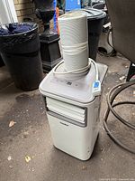 Front and top view showing Comfee portable AC, exhaust hose, power cord and wheels