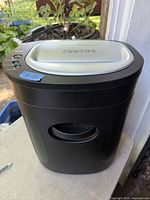 Front and side view of the black Royal paper shredder showing pull-out bin and overall condition