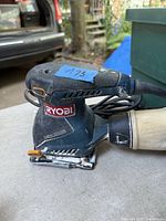 Ryobi corded finishing sander side view showing body, sanding pad, and dust port
