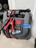 Front view of Schumacher battery charger with cables and clamps visible