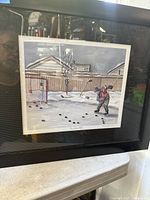 Full view of framed print under glass