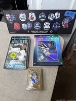 All four items together: plaque, VHS, DVD, playing cards