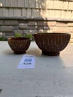 Both bowls side by side showing size difference and exterior carving