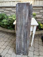 Full view of rustic lacquered wooden board standing vertically