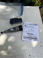 Dremel 7300 tool, charger base, manual