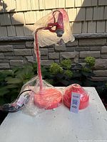 Lamp base, arm and power cord wrapped in plastic