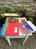Full lot on table with folders, rulers, paper packs, clipboard, file box