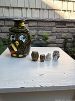Group shot of ceramic owl cookie jar with five smaller owl figurines