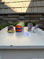 All four ceramic shoe figurines on tabletop