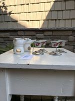 side view showing all six butter warmers on table