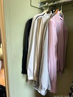 Rack of assorted vintage blouses on hangers