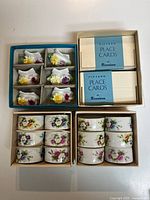 Overview of boxed napkin rings, place-card holders, and Dennison place card boxes