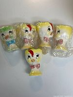 Five ceramic duck egg cups, four wrapped one unwrapped