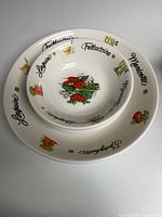 Large serving bowl with one individual bowl nested, showing rim graphics and center motif