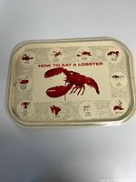 Full view of rectangular tin tray showing lobster graphic and instructions