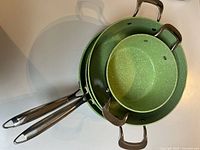 Stacked view of all three cookware pieces showing interiors and handles