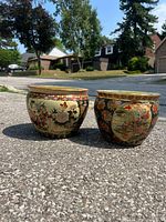Two porcelain planters side by side showing full exterior patterns and rims