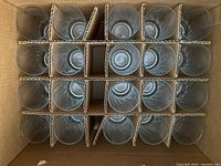 Top view of 20 clear tall glasses in corrugated divider box