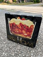Retail box showing clear glass trifle bowl filled with strawberries, product details visible