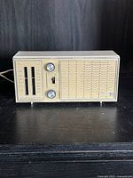 Front view showing controls, tuning scales, speaker grille