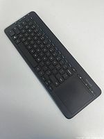 Top view of Microsoft wireless keyboard showing full key layout and integrated touchpad
