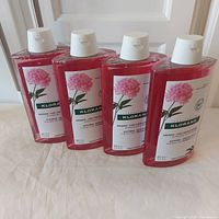 Front view of four Klorane 400 ml shampoos