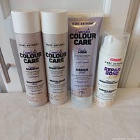 Group shot of all four Marc Anthony hair products standing upright