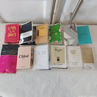 Full set of twelve carded perfume samples laid out
