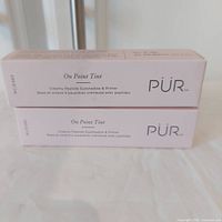 Two boxed PUR On Point Tint eyeshadow & primer products stacked