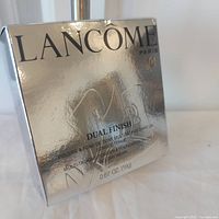 Front of sealed Lancome Dual Finish powder foundation box showing branding and weight