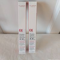 Front view of two Clarins Wonder Volume Mascara XXL boxes