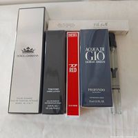 Front view of all six fragrance items; five boxed, one YSL Y vial visible