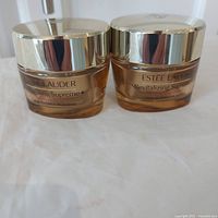 Front view of two sealed Estée Lauder Revitalizing Supreme+ Youth Power Cream jars