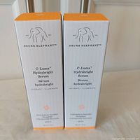 Front view of two boxed serums