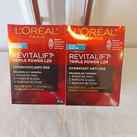 Front view of two sealed L'Oreal Revitalift Triple Power moisturizer boxes