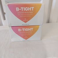 Front view of both sealed Maelys B-Tight Booty Mask boxes