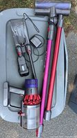 Entire lot showing vacuum body, wand, motorhead, charger, tool, wall mount