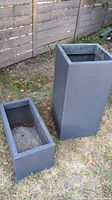 Rectangular and tall square charcoal galvanized planters on grass