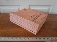 Side view showing full stack of pink 80-page workbooks