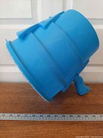 Side profile of blue AirZooka showing barrel shape