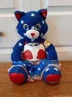 Full view of Build-A-Bear star cat plush in Wonder Woman outfit