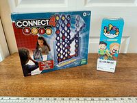 Both boxed games on table with measuring tape