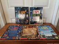 Five I Spy hardcover books laid out, two standing, three flat