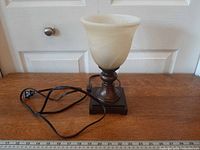 Front view of lamp showing shade, base and cord