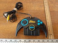 Top view of Batman controller with RCA cable and rulers showing size