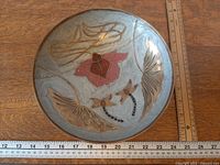 Top view of brass cloisonné bowl beside rulers showing overall size